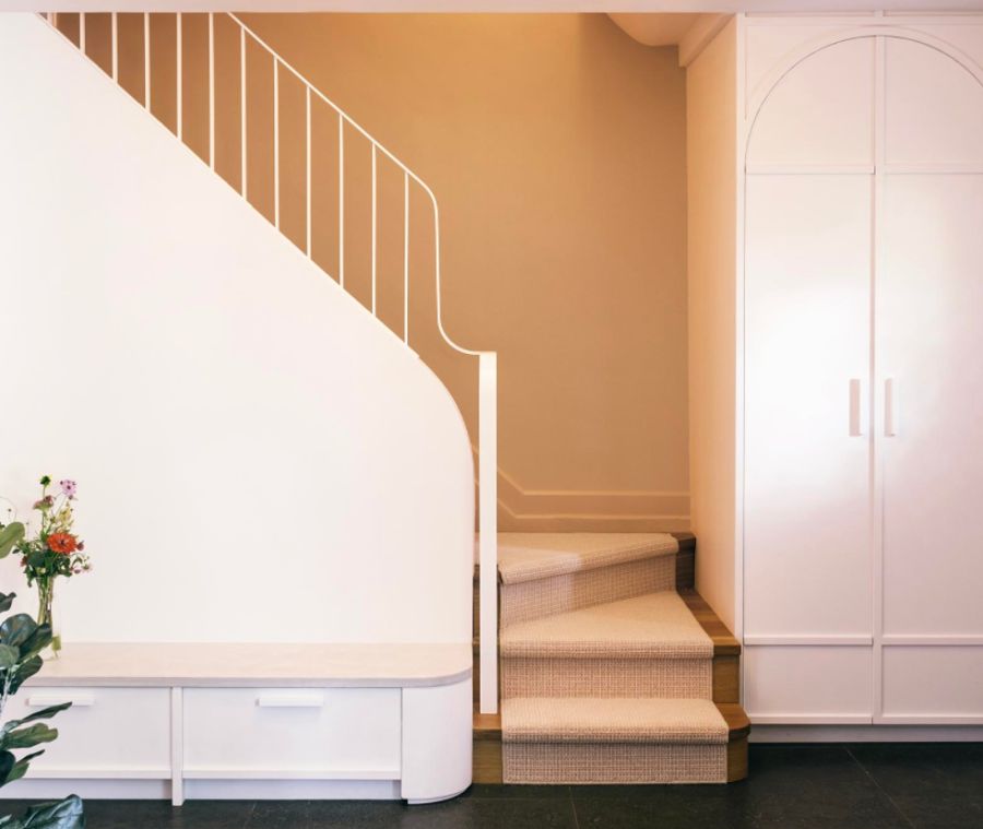 Staircase makeover featuring a curved metal railing