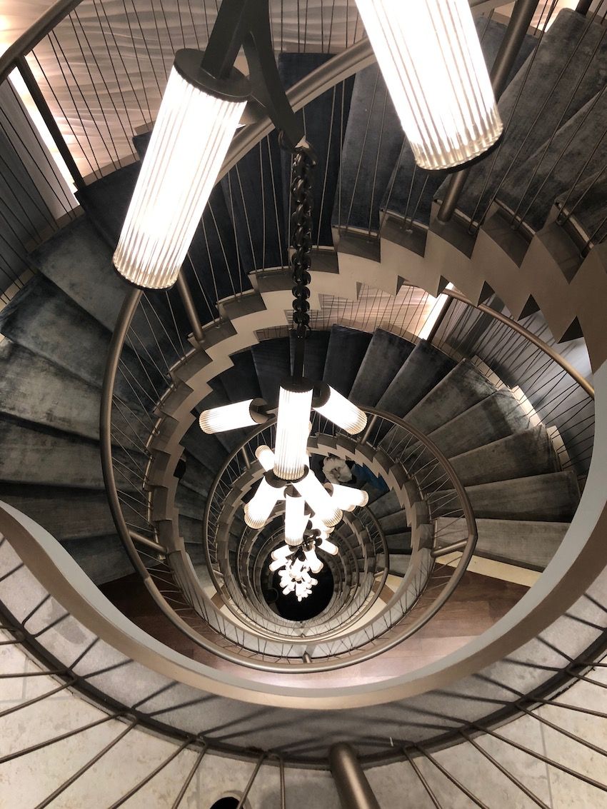 All six levels are linked with an elegant swirl of a staircase and a 60-foot light fixture by Cameron Design House.