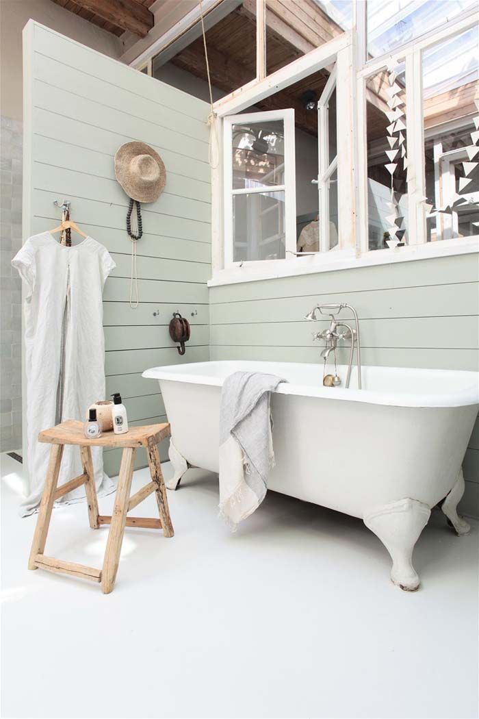 Stalking bathroom with beadboard walls and bathtub