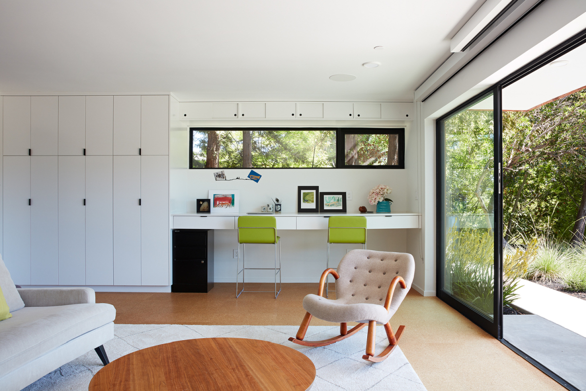 Big sliding glass doors allow the office and the adjacent deck to become a continuous space