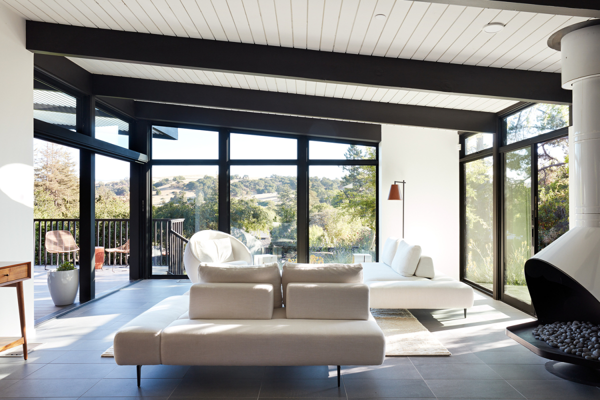 TheThe new living area features a slightly asymmetrical roof with black beams going across