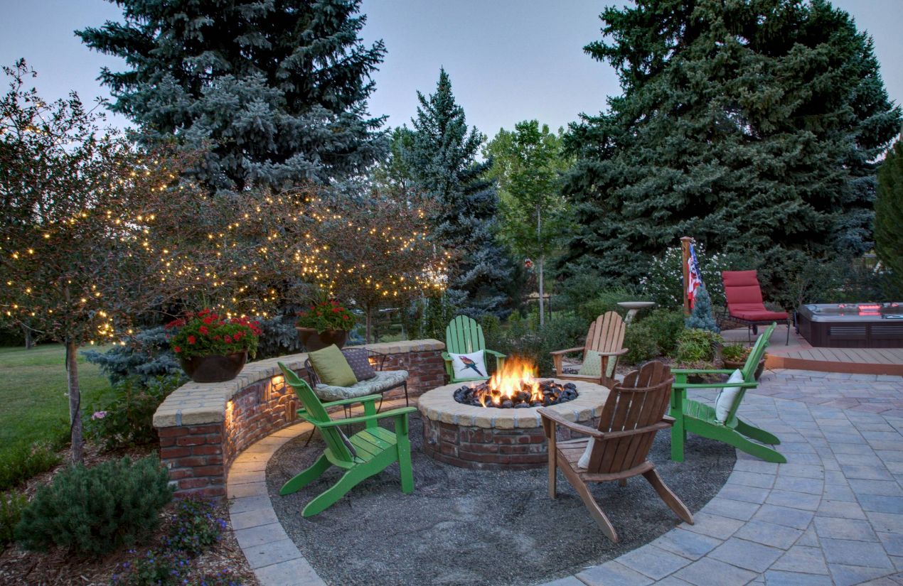 String lights for outdoor trees and fire pit made from bricks green chairs