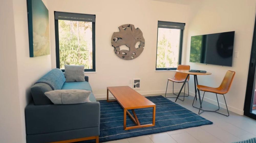 The Kuono house bedroom with a wood framed bed and matching side tables