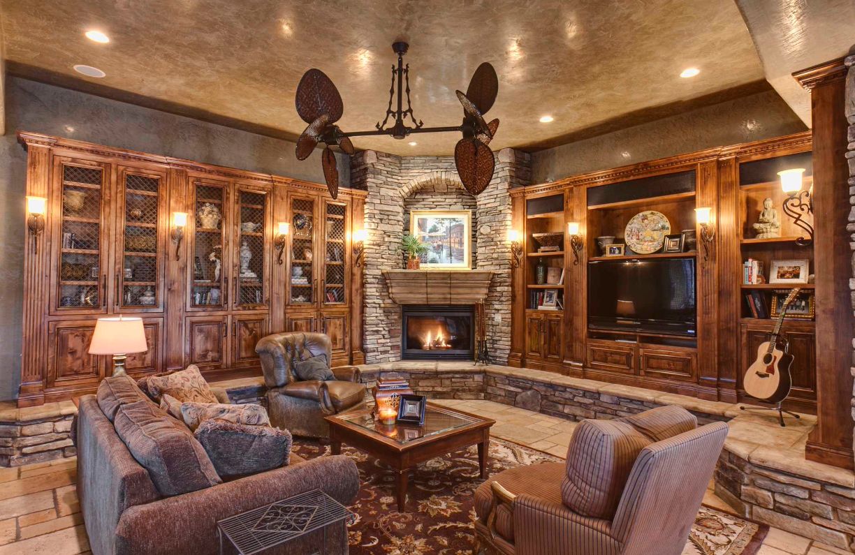 The most beautiful living room with stone corner fireplace