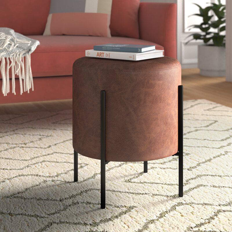 The round Degregorio leather ottoman