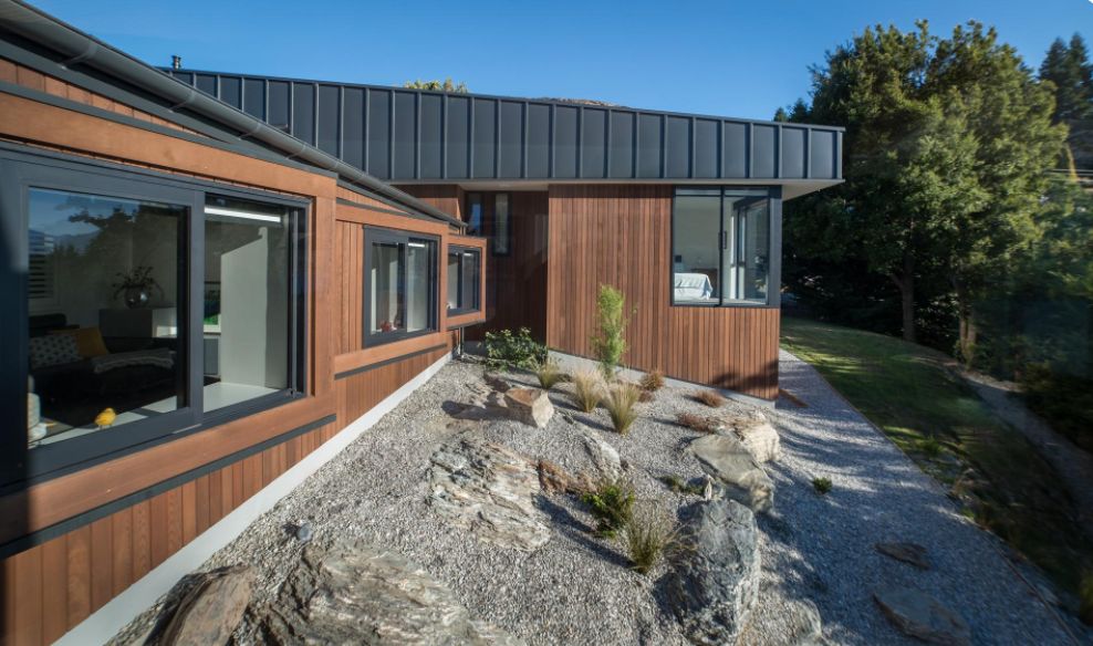 This Hillside Home With Black Metal Siding front view