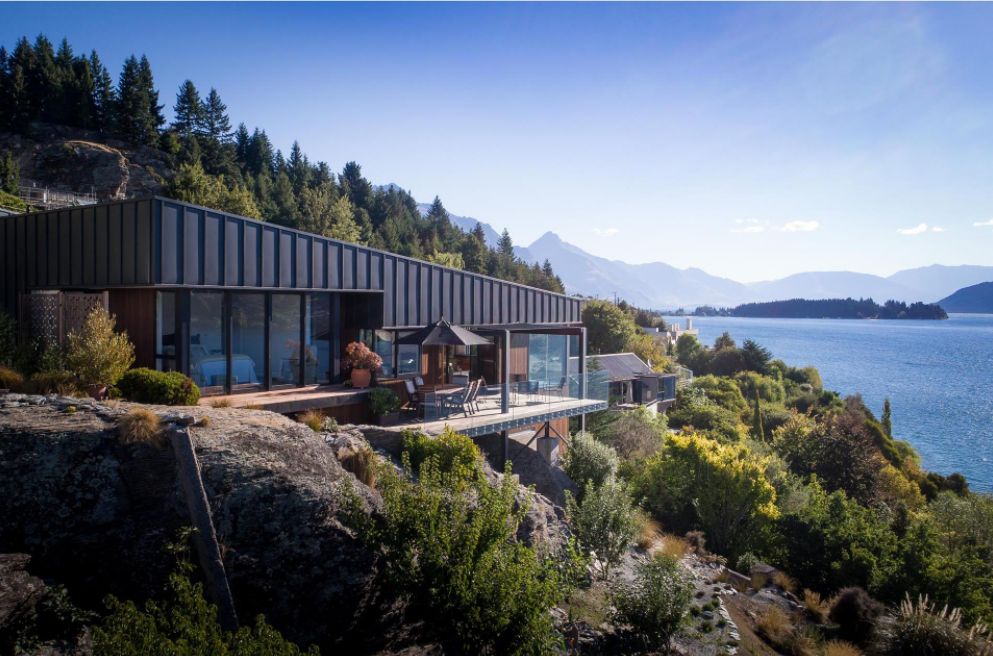 This Hillside Home With Black Metal Siding side view