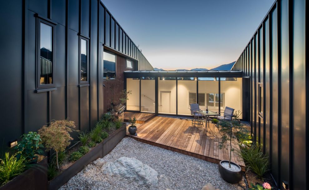 This Hillside Home With Black Metal Siding terrace