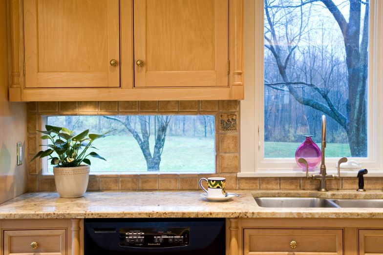 Traditional kitchen with granite countertop and window