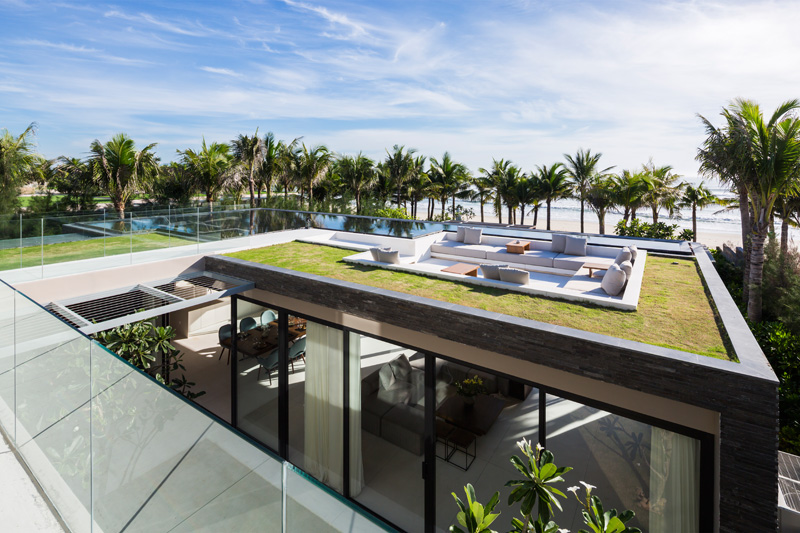 Tropical bechfront house with rooftop seating