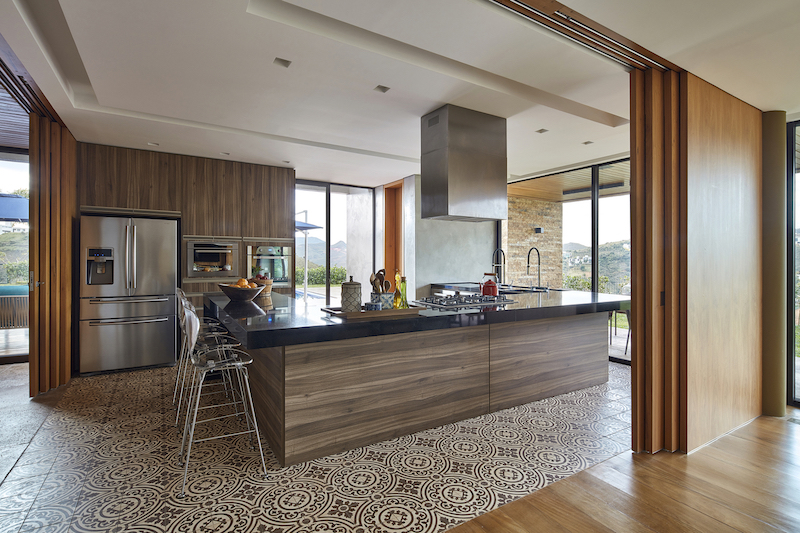 The floor tiles and all the wood and exposed brick give the kitchen a welcoming look and feel