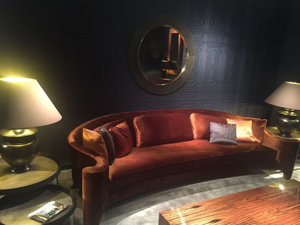 Velvet sofa and end tables lighting with round mirror on the wall