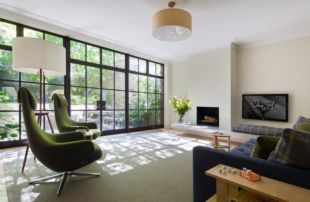 The green accent chairs in the family room seem to mimic the view outside on the patio.