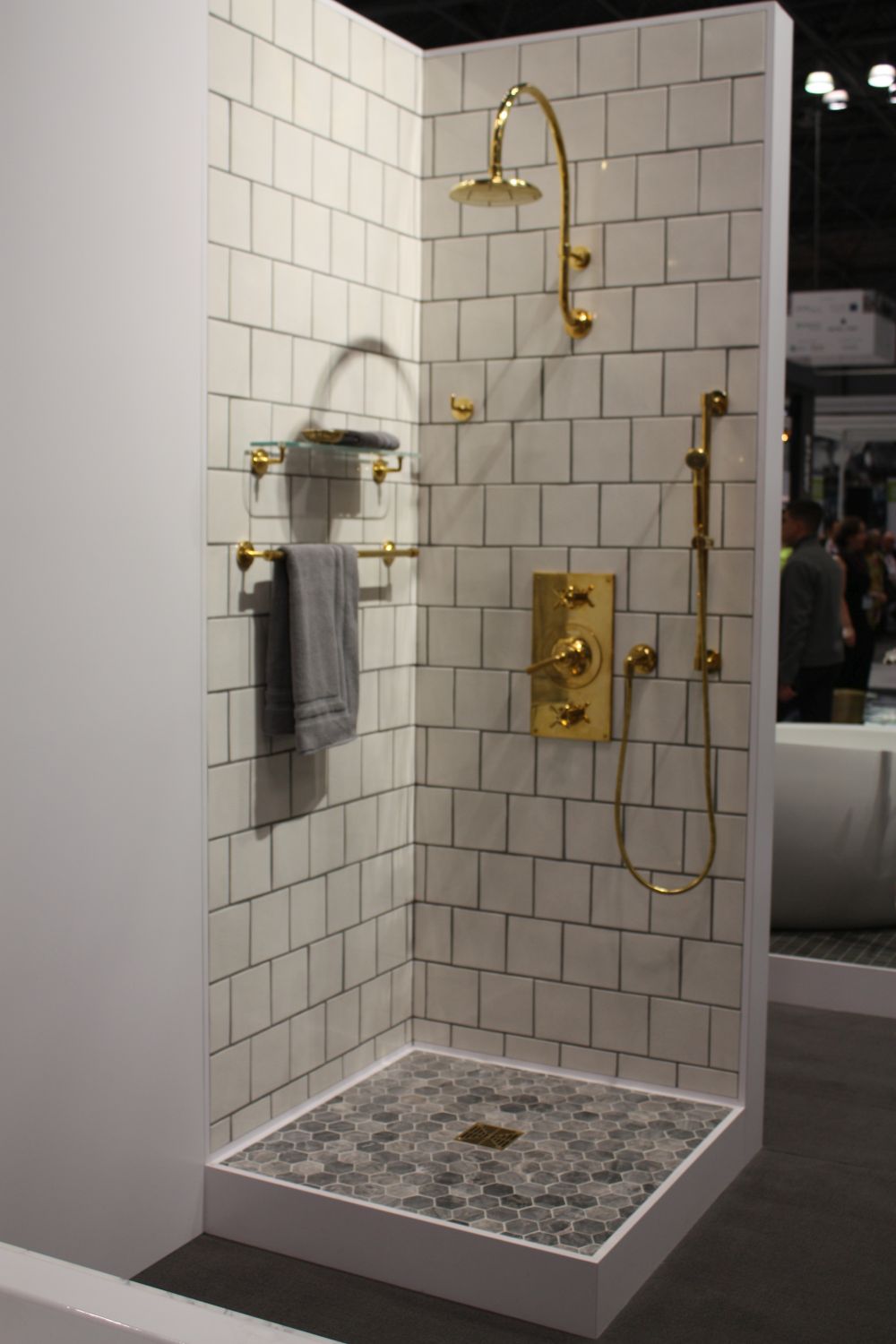 Walk in shower with gold accessories