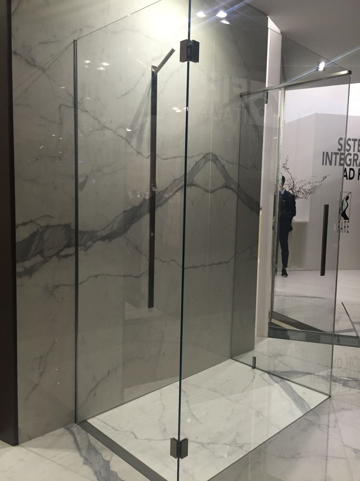 Walk in shower with marble tiles and glass