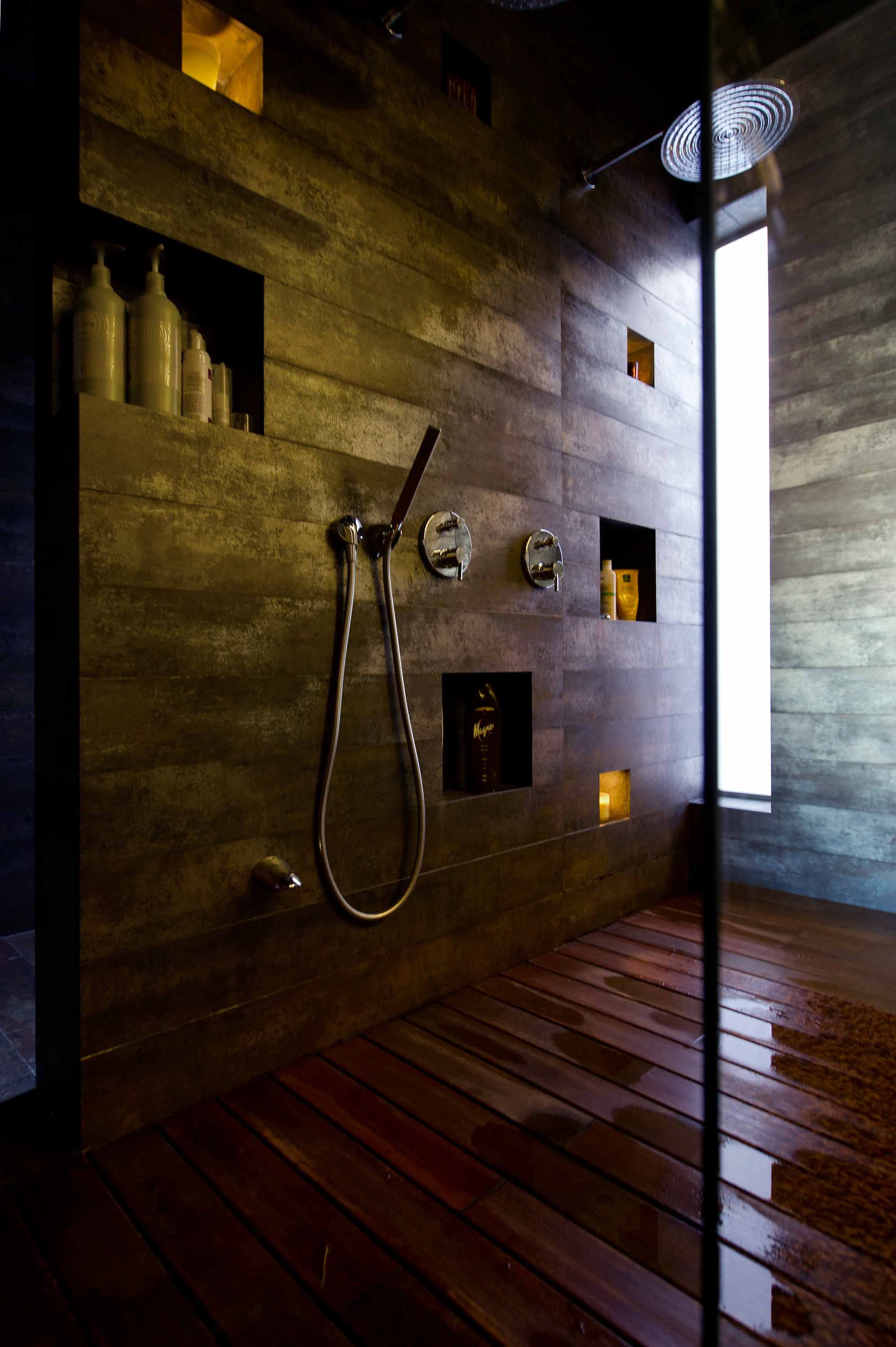 Inset spaces provide enough shelving for shower products and accessories like candles.