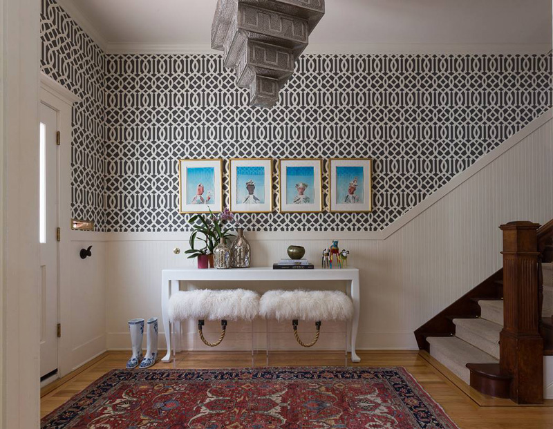 Wallpaper foyer with small console and lucite ottomans