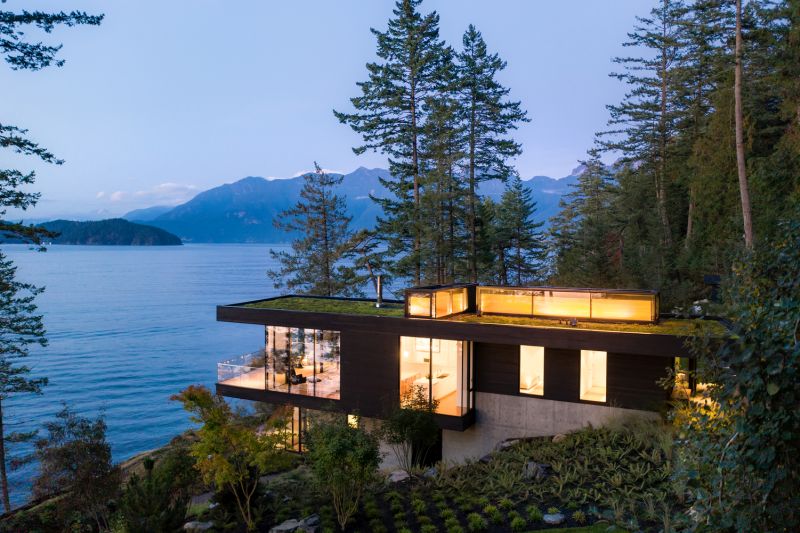 Waterfront cabin with a forest backdrop lake