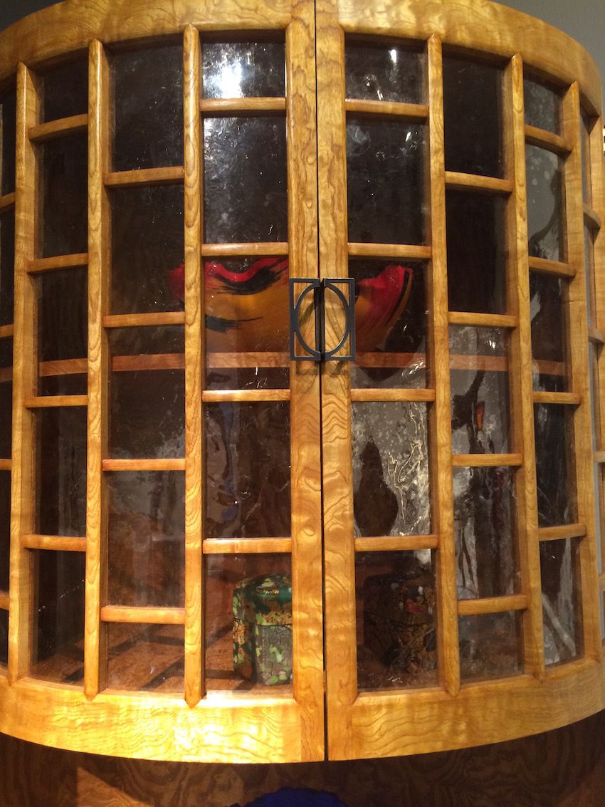 Instead of glass panes, Hurewitz uses mica to serve as windows into the display area of the armoire.