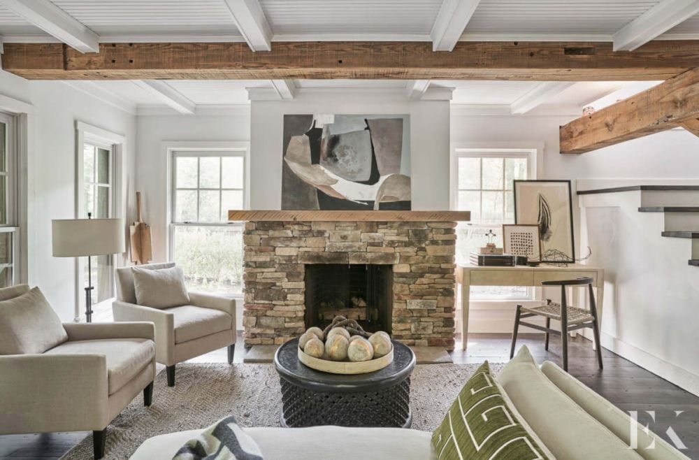 White Living Room with stone fireplace and staircase