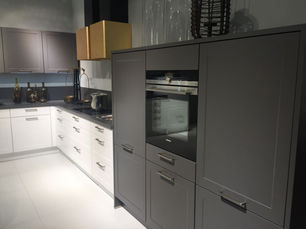 White and grey kitchen cabinets with a strong gold hood