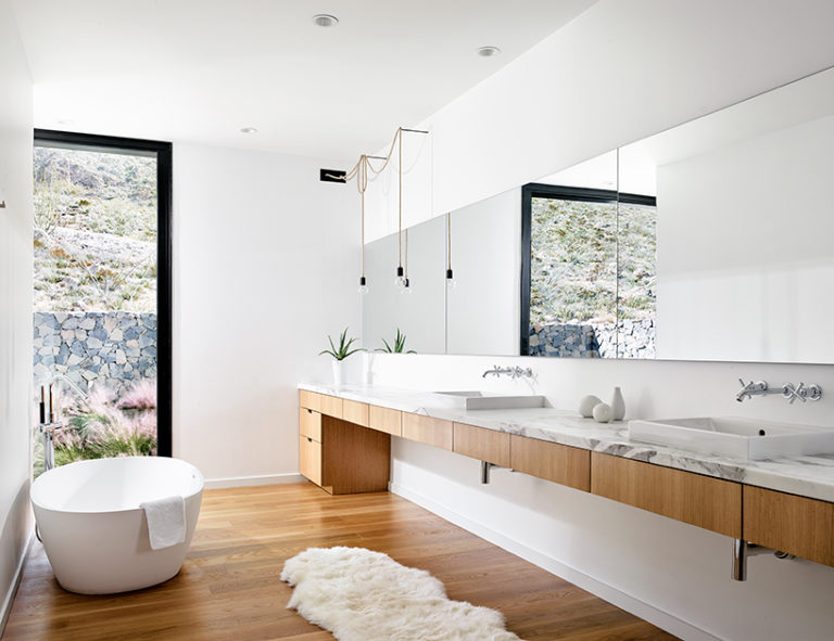 White bathroom design with wood floor and full wall mirror