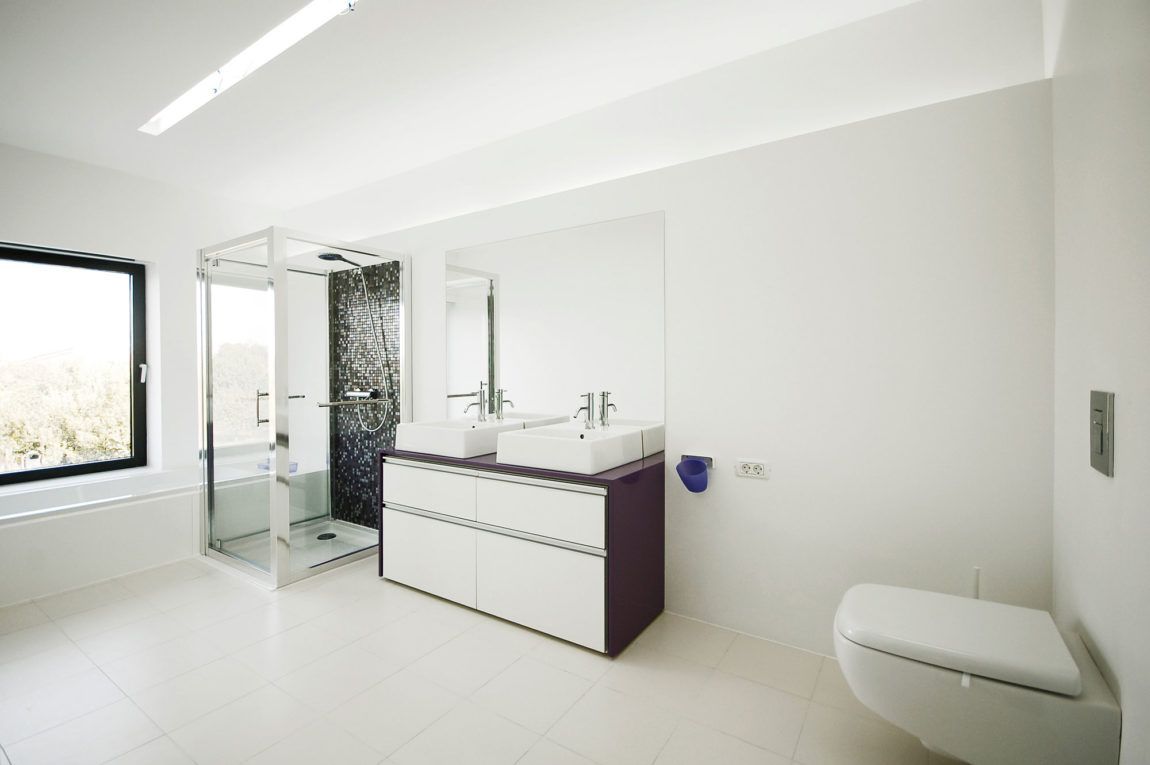 White bathroom with accent shower wall in black