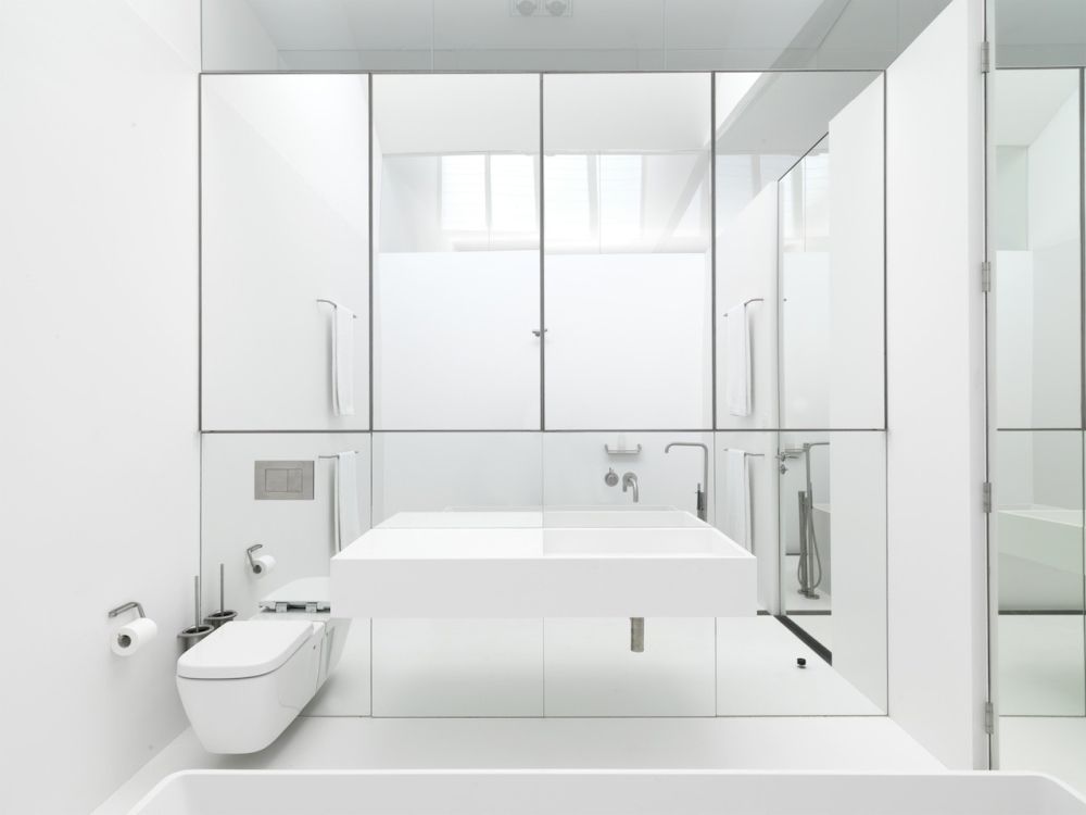 White bathroom with mirrored wall decor