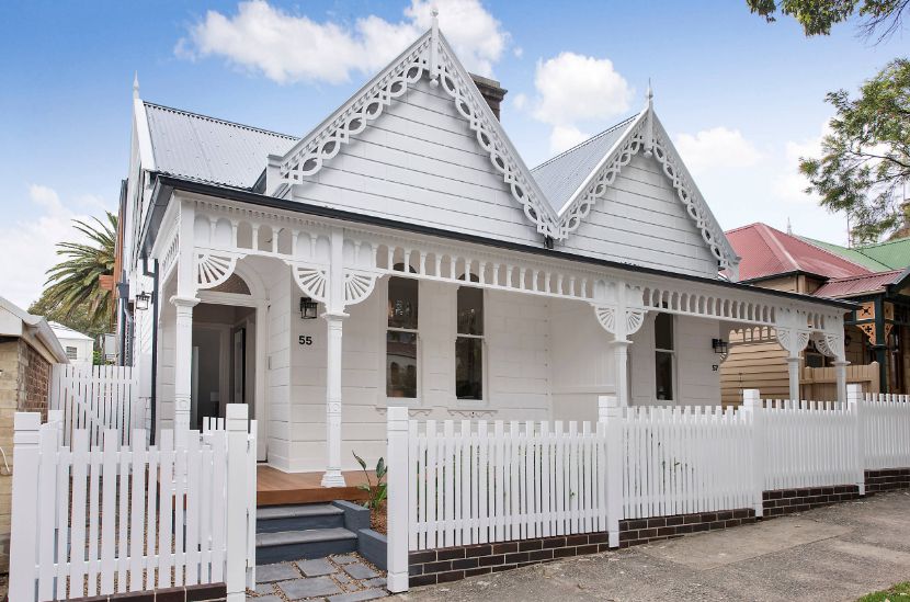 White cottage house with picket fence