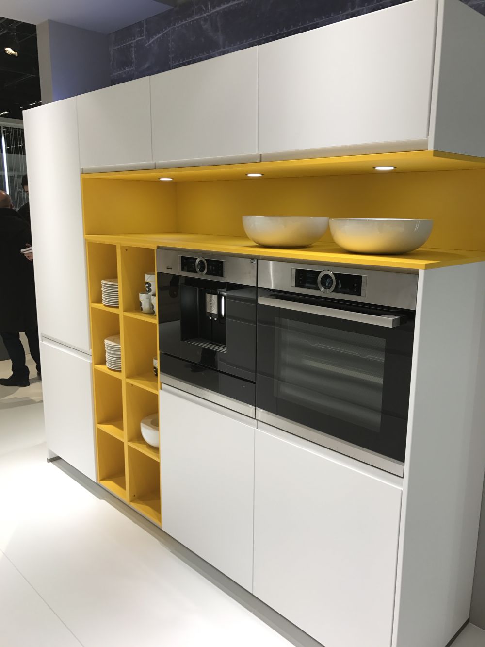 White kitchen with strip of yellow for shelves