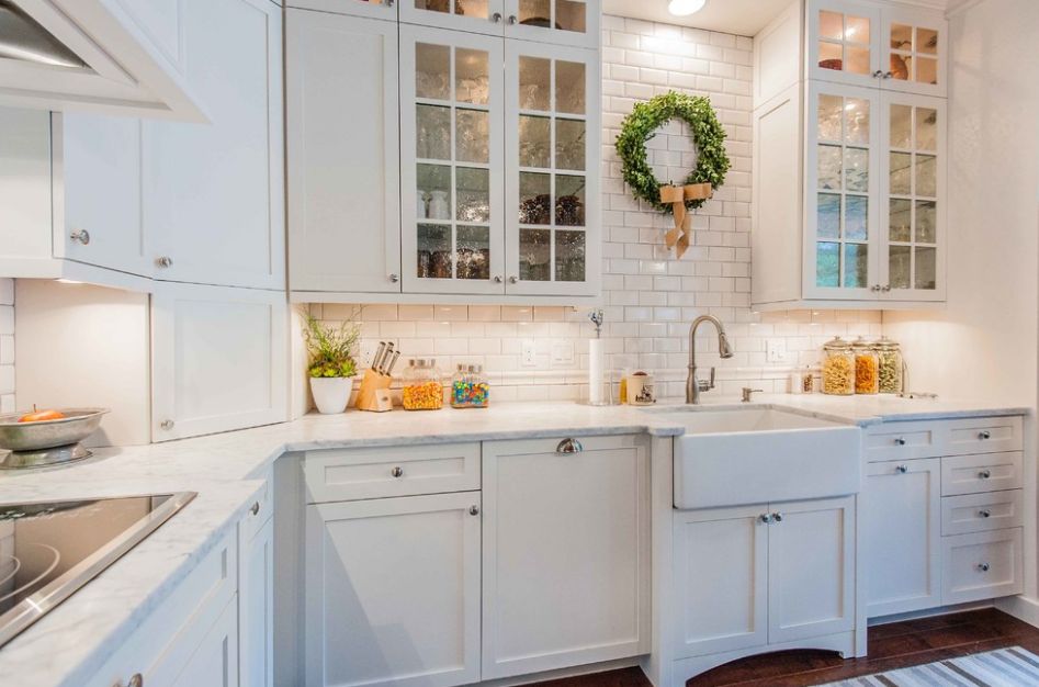 White kitchen design with subway tiles and seeded glass doors