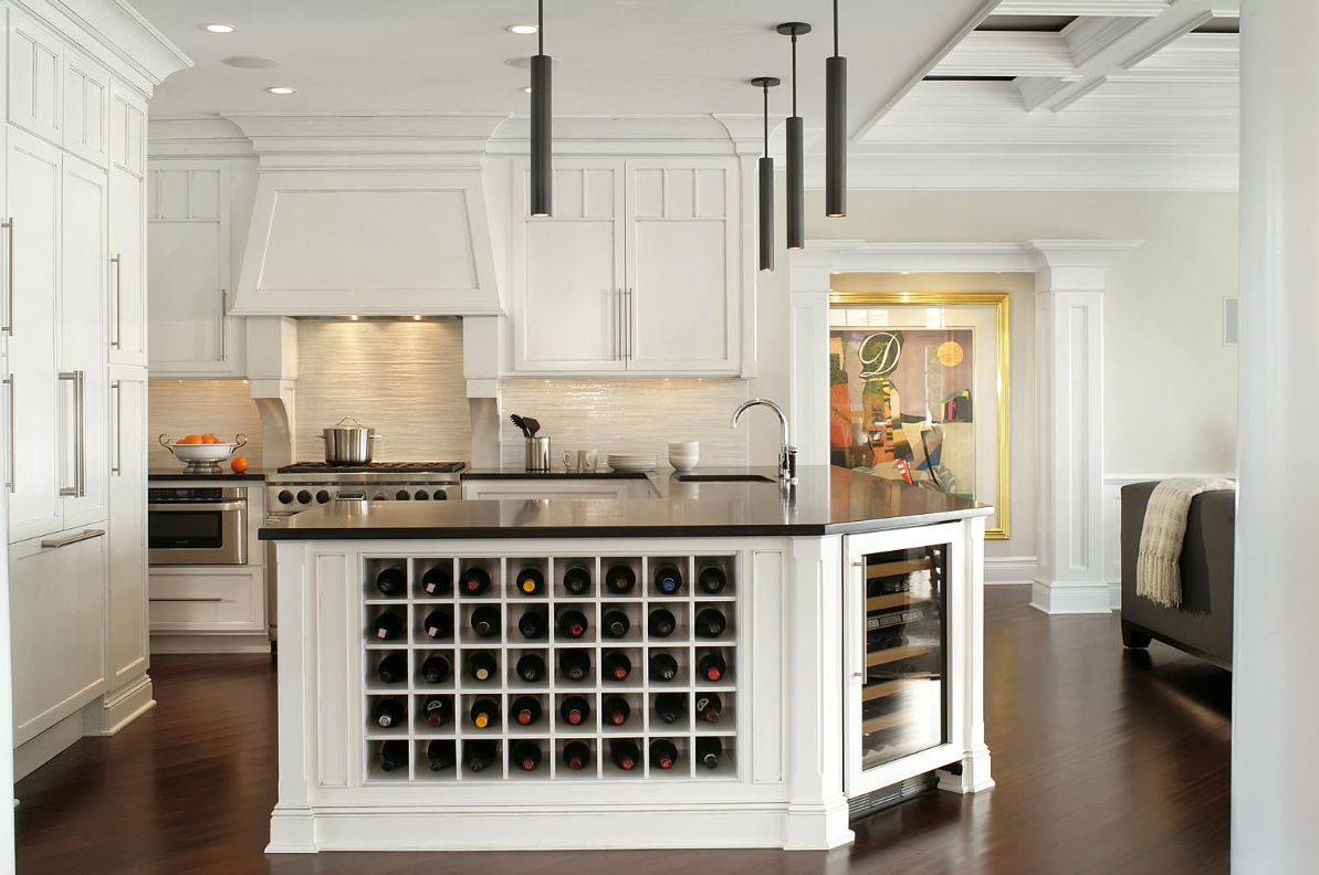 White kitchen with built in fridge island and black pendants