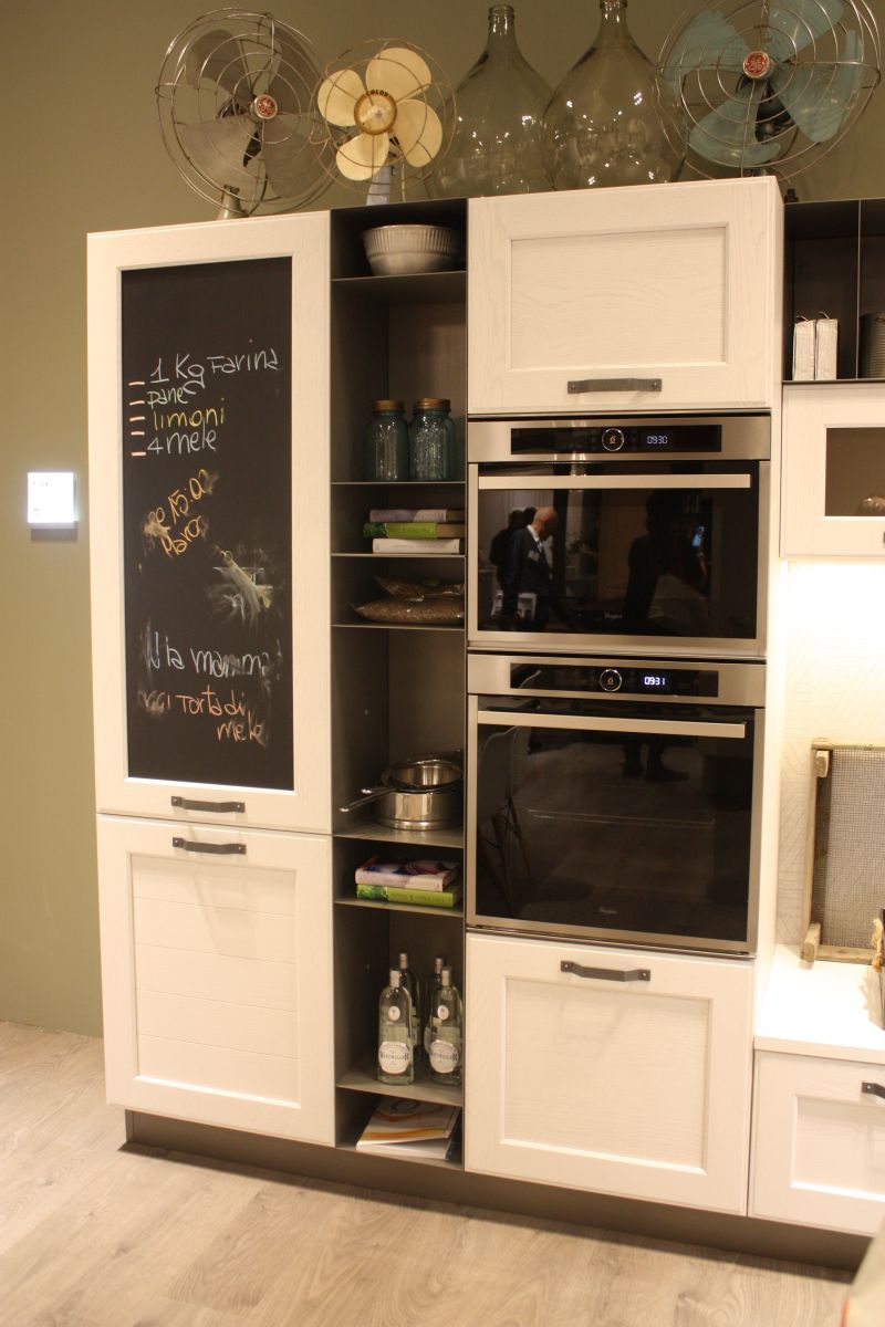 White kitchen with built in shelves and chalkboard