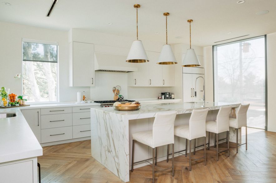 White kitchen with laminate floor and marble island