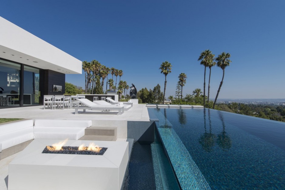 White residence with infinity pool and fire pit