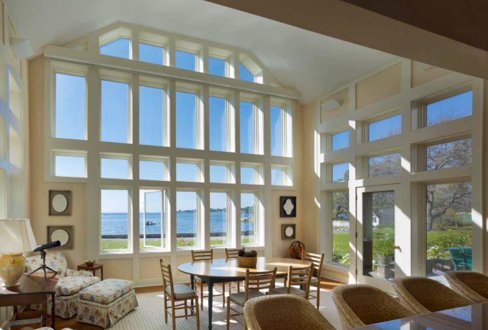 White sunroom decor with large windows framed