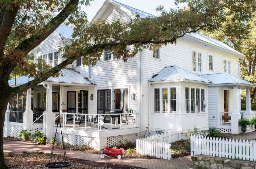 White traditional house with picket fence