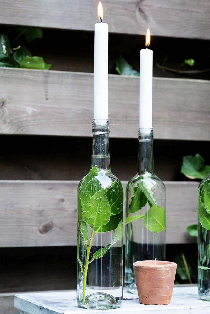 Clear glass bottles as candle holders