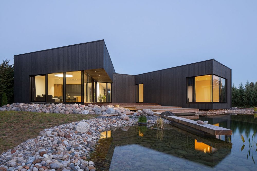 Wood cladding Black House on Nevezis River Slope