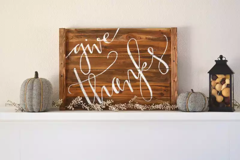 Wood holiday sign above fireplace