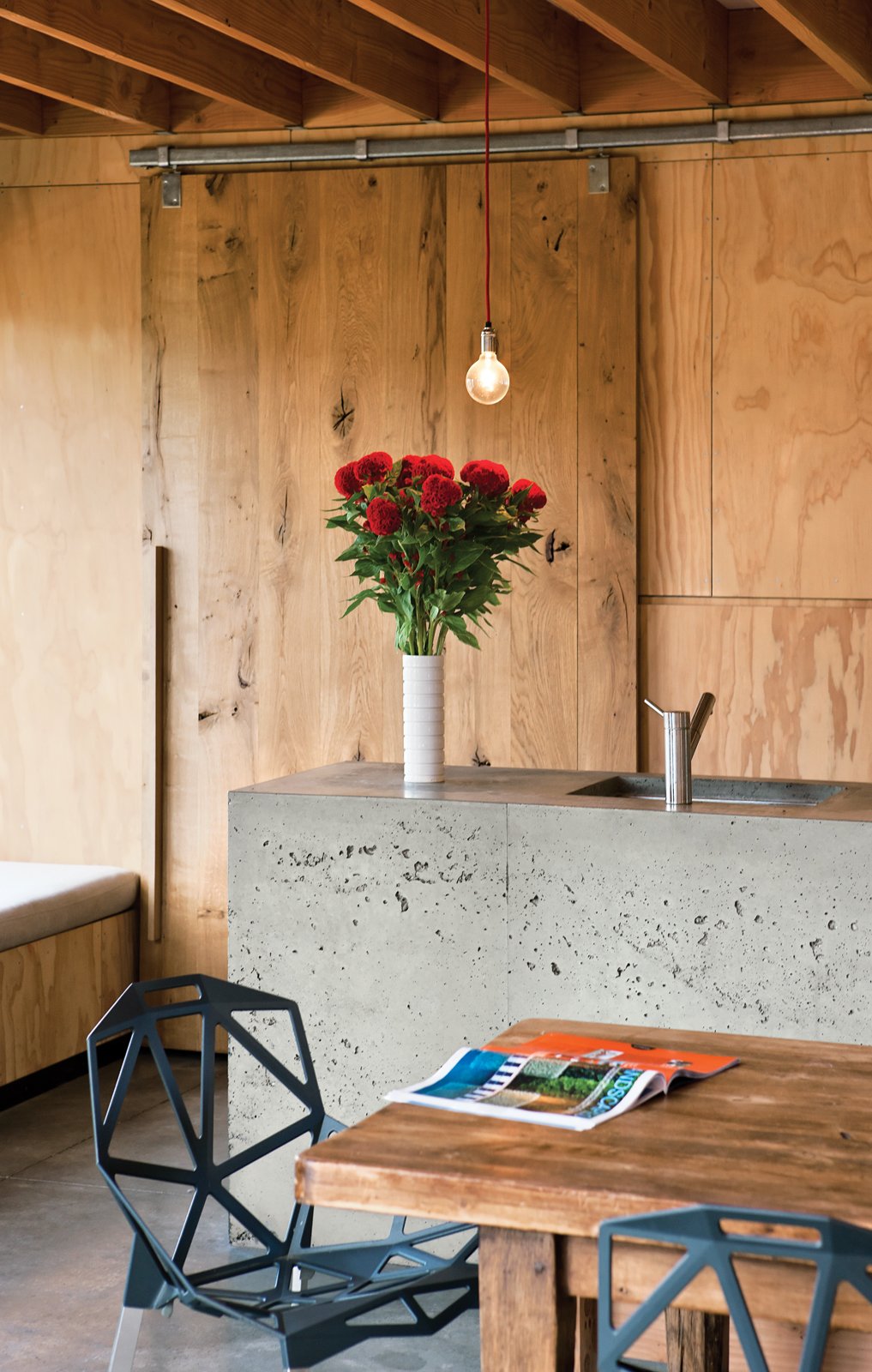 Wood walls paneling and cement kitchen island