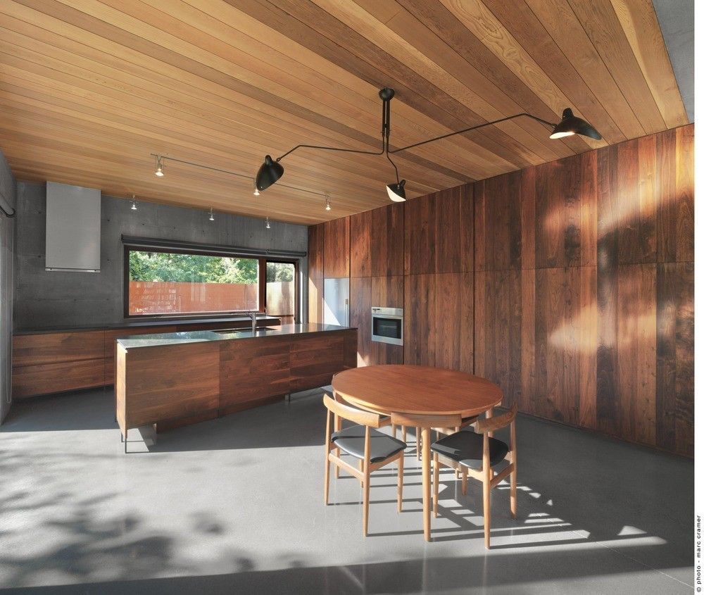 Wooden kitchen with hidden storage spaces and polished floor