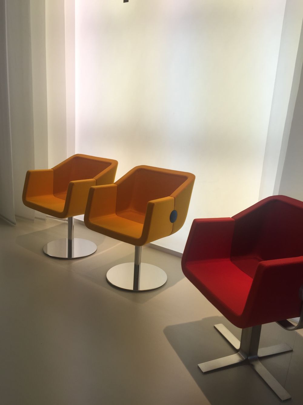 Yellow and red swivel armchairs