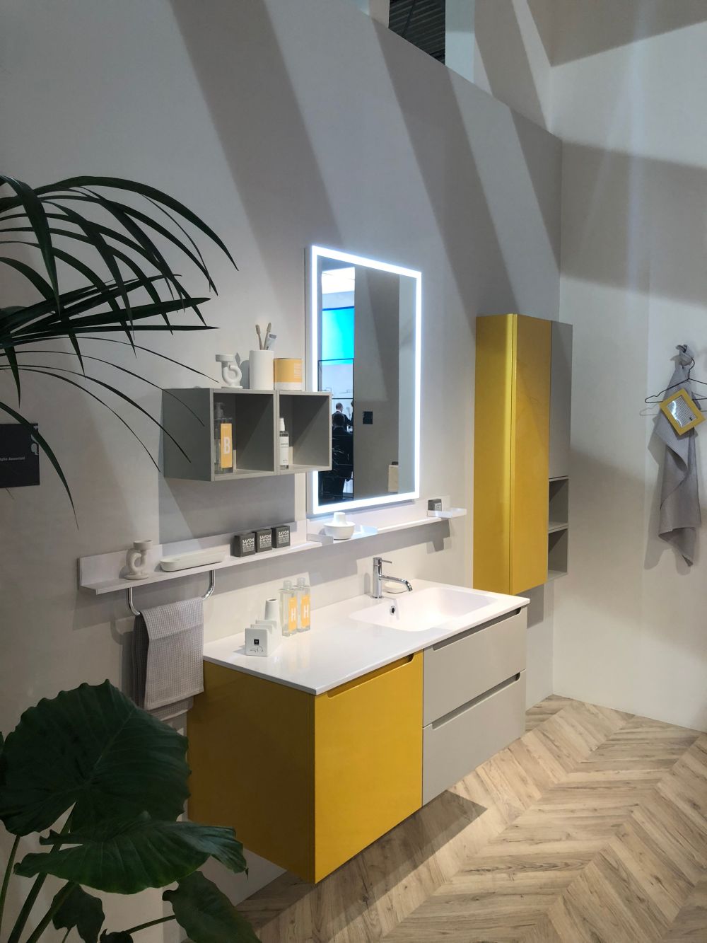 Yellow bathroom vanity and wood chevron floor