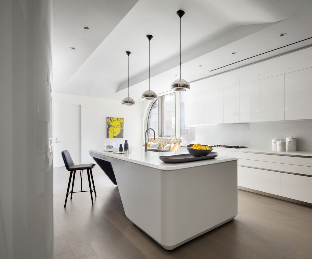 The unique kitchen island adds interest to the otherwise linear space.