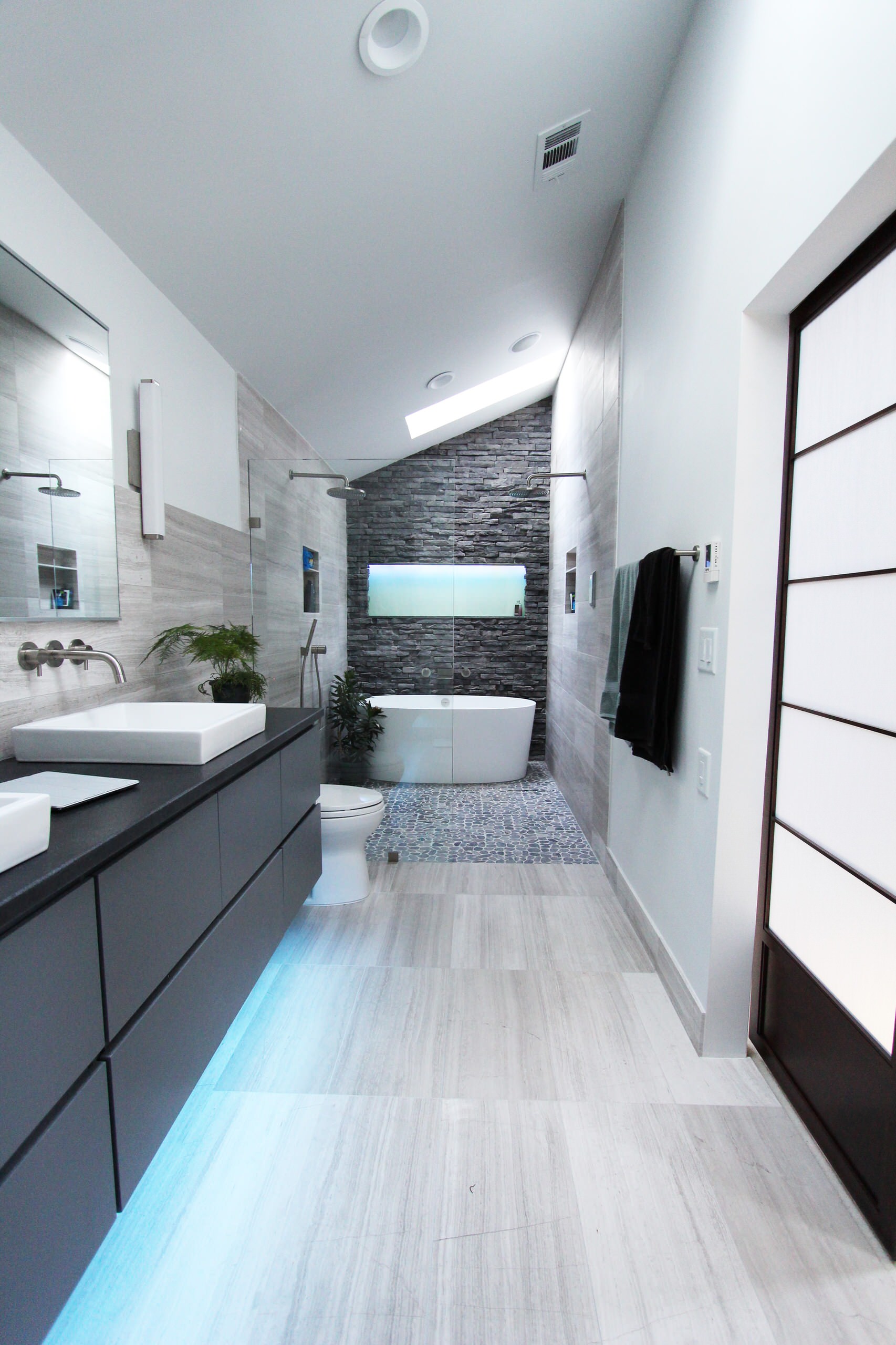 Zen bathroom rock wall blue floor