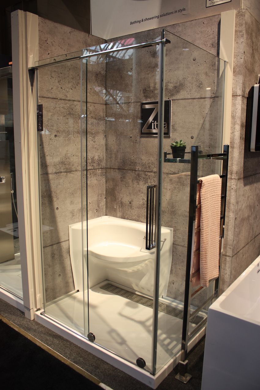 The corner shower also features a seat and long drain.