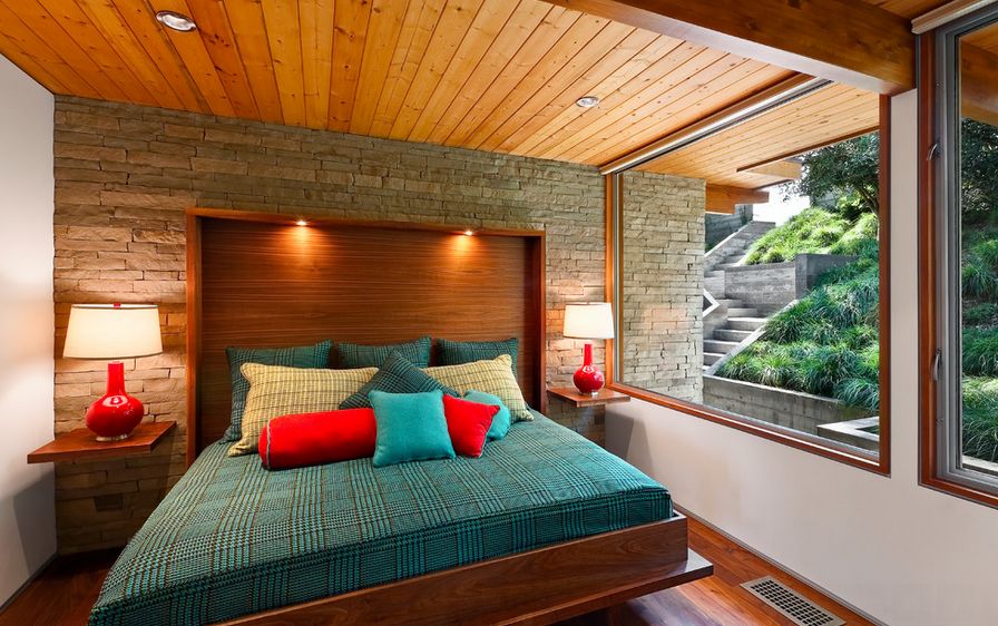 Bedroom featuring shelf nightstands and wood ceiling