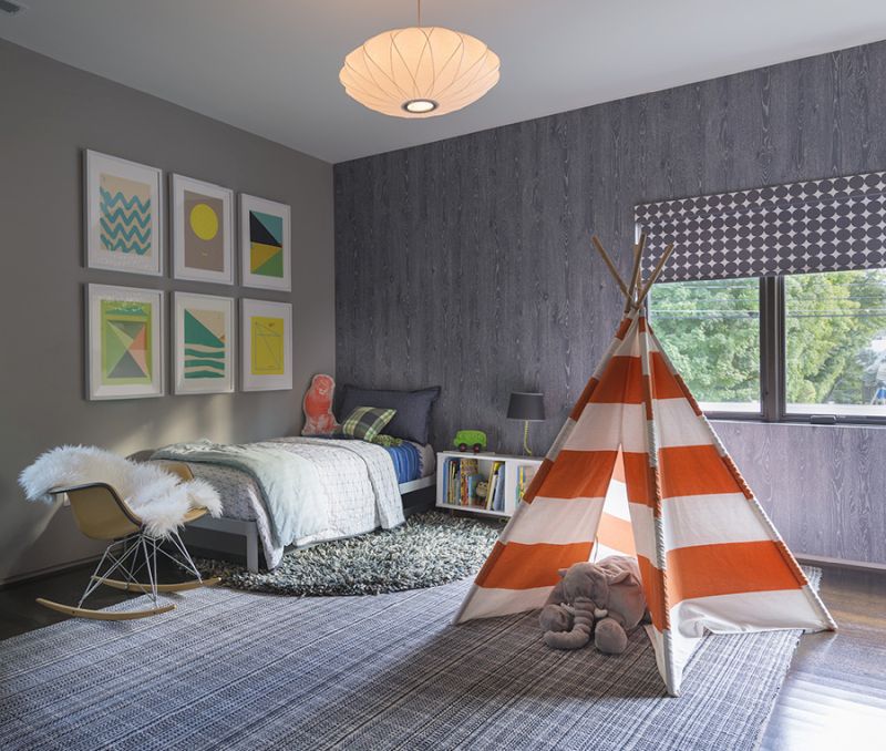 Childrens room with tent in the middle of the room and wood style wallpaper