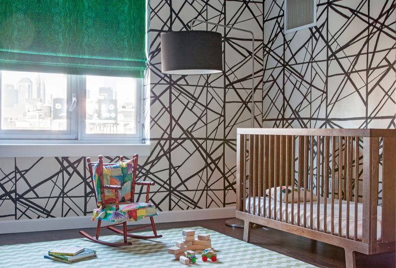 Childrens room with walls with painted lines and rocking chair